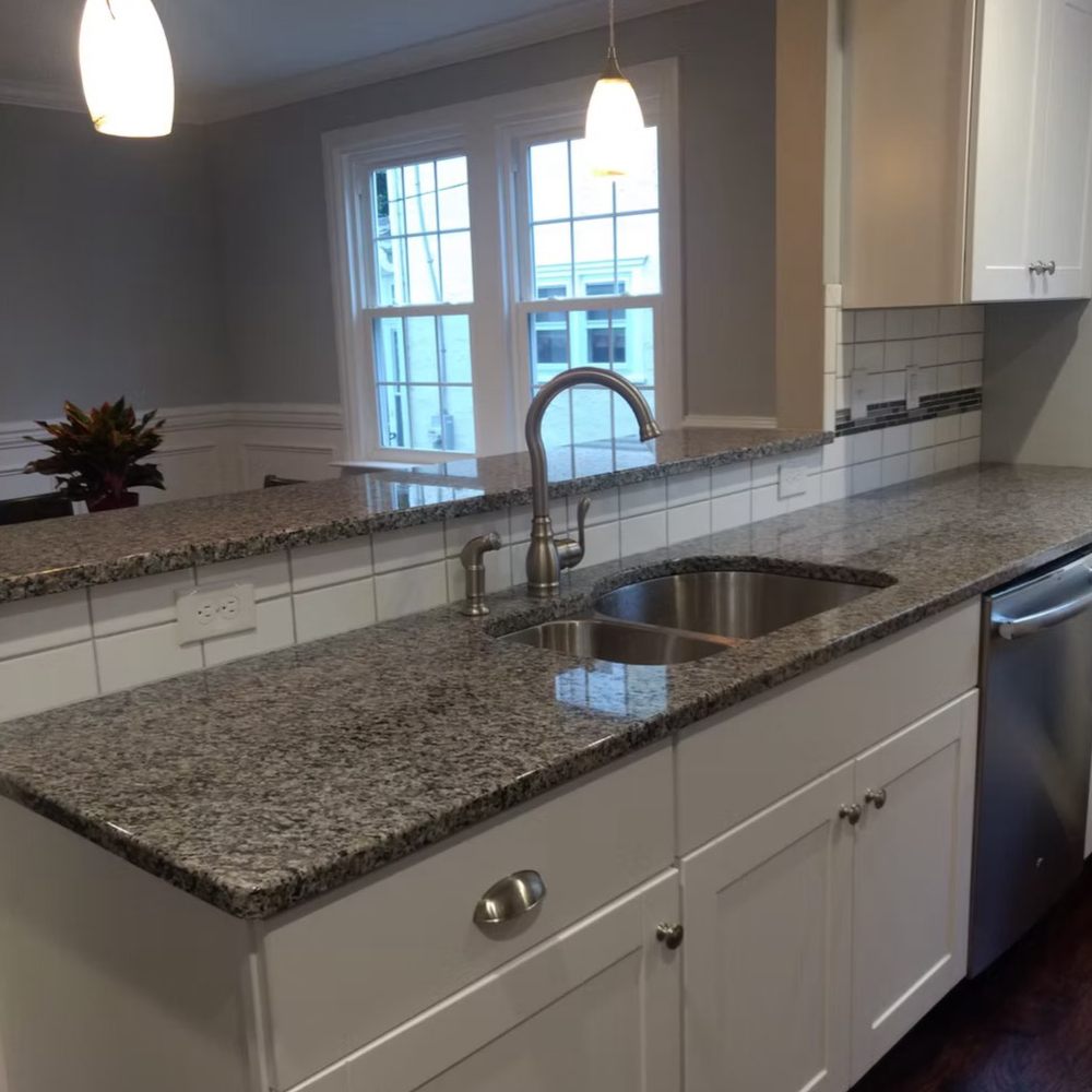 A kitchen with granite counter tops and stainless steel appliances