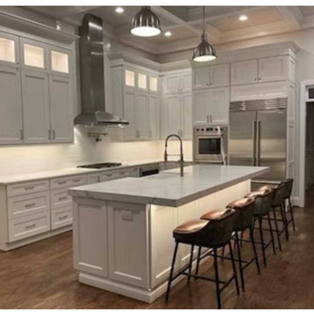 A kitchen with white cabinets and stainless steel appliances