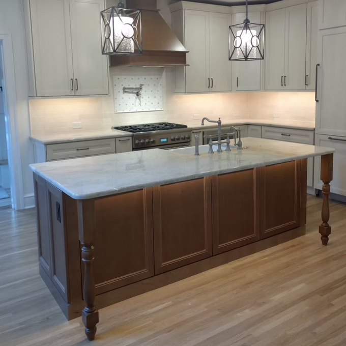 A kitchen with a large island in the middle