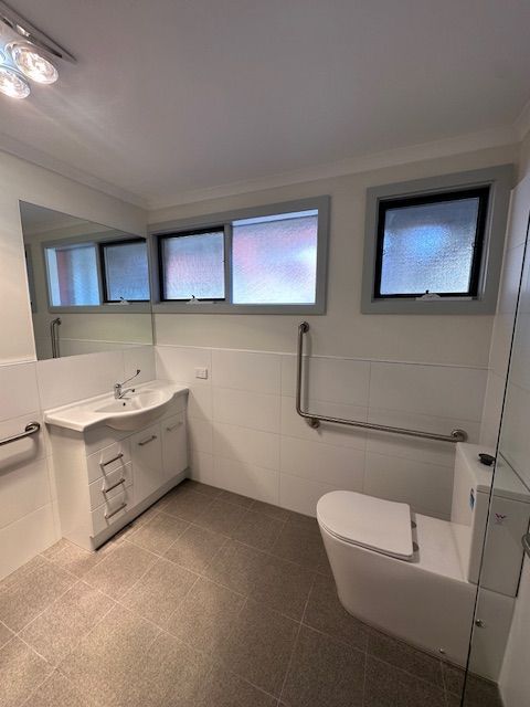 Accessible Bathroom with White Fixtures, Grab Bars — Mezcon Group in Eaglemont, VIC