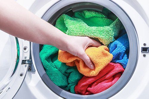 Coloured clothes put in the washing machine for cleaning
