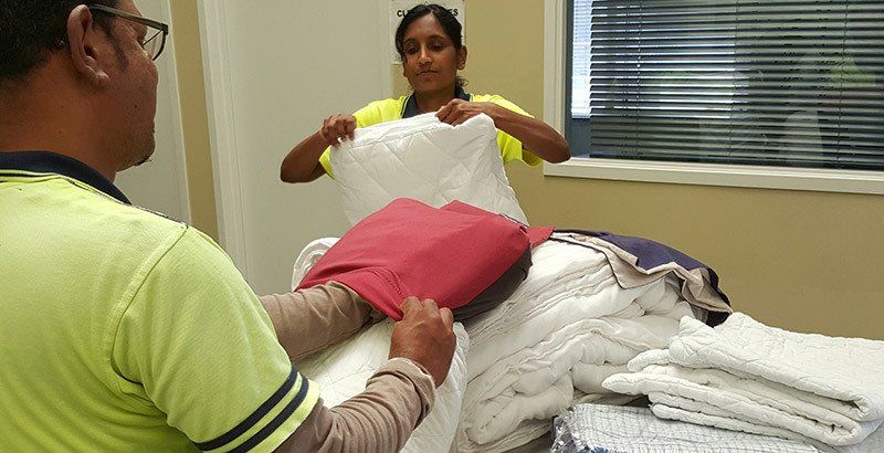 Employee folding the washed clothes