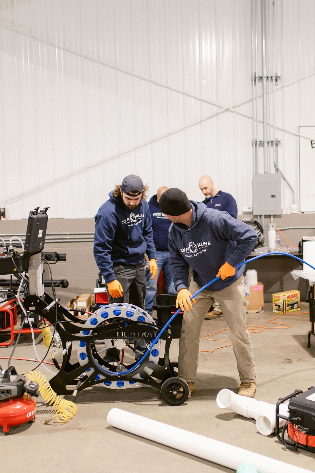 A group of men are working on a machine in a garage.