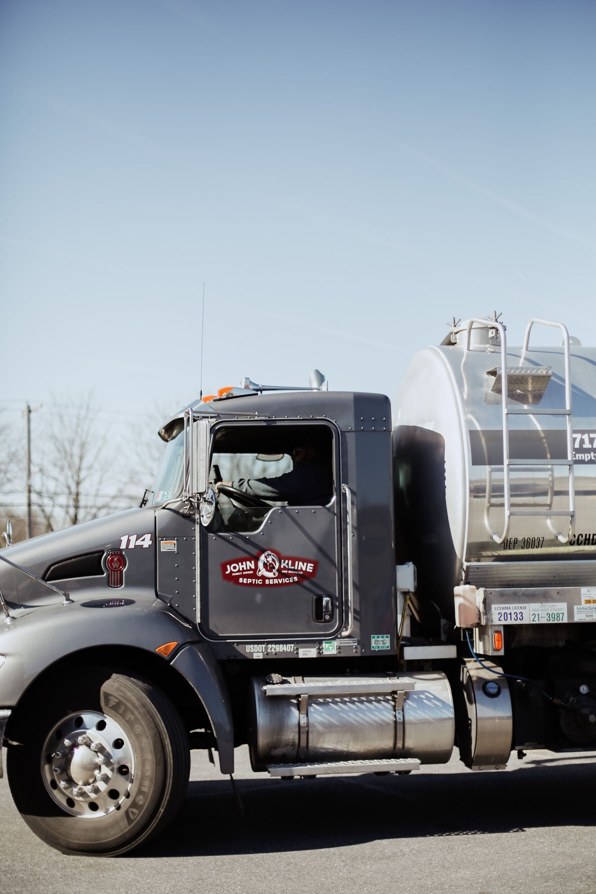 A semi truck is parked on the side of the road.