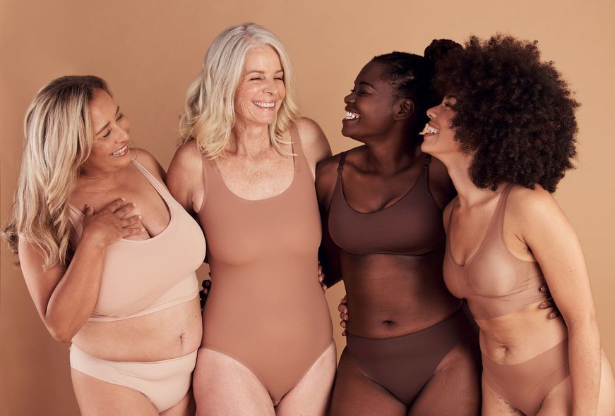 A group of women in underwear are posing for a picture together.