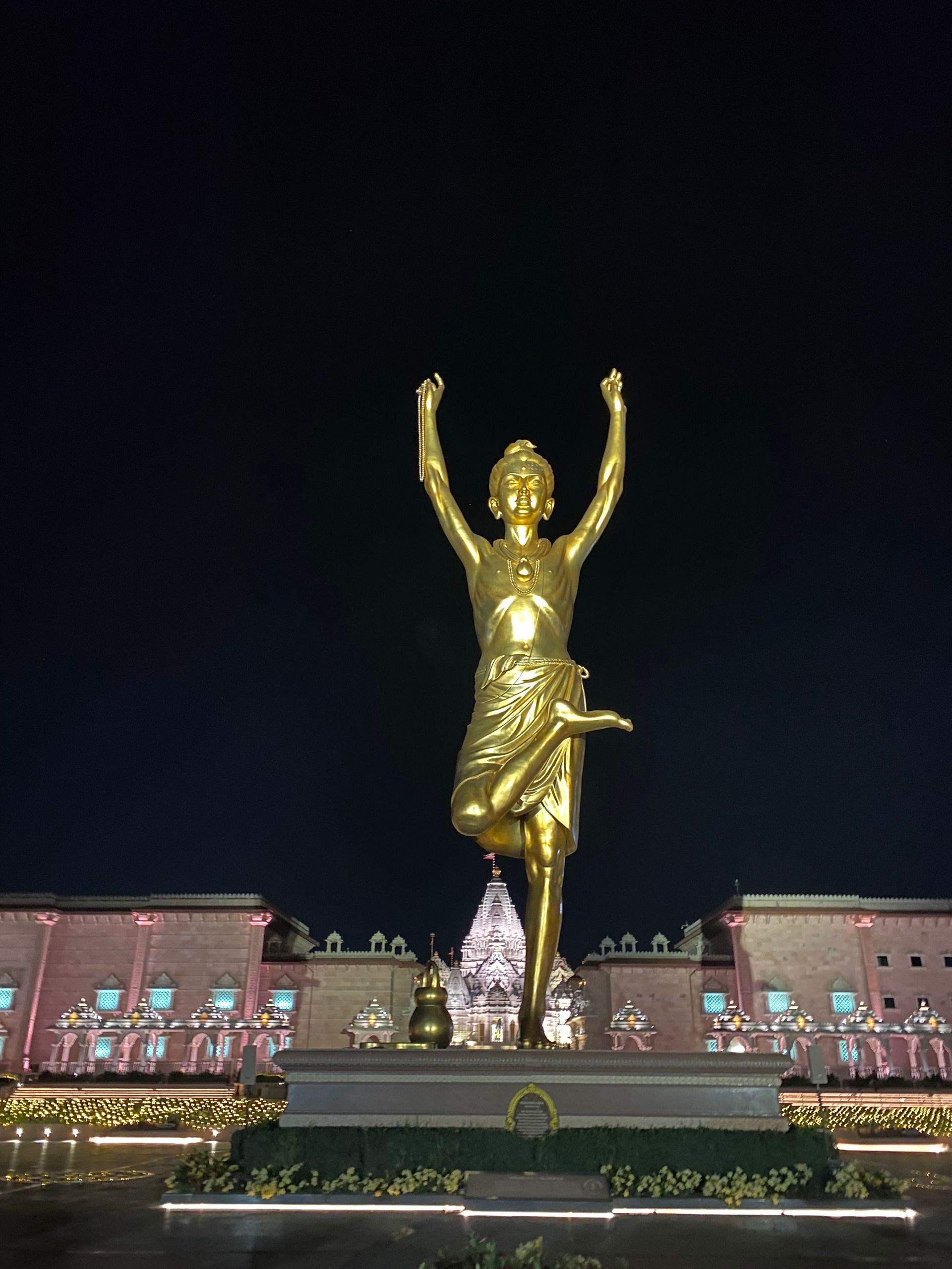 A statue of a person with their arms in the air