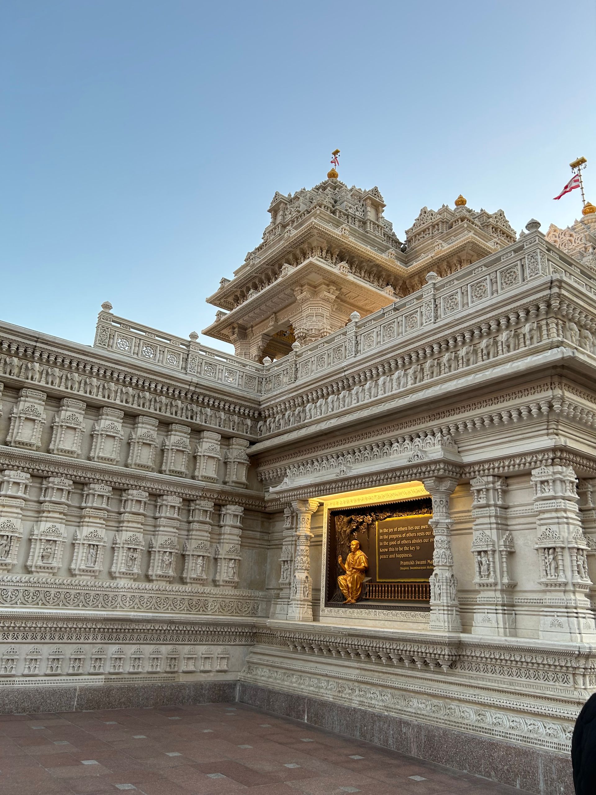 A man is standing in front of a large temple.