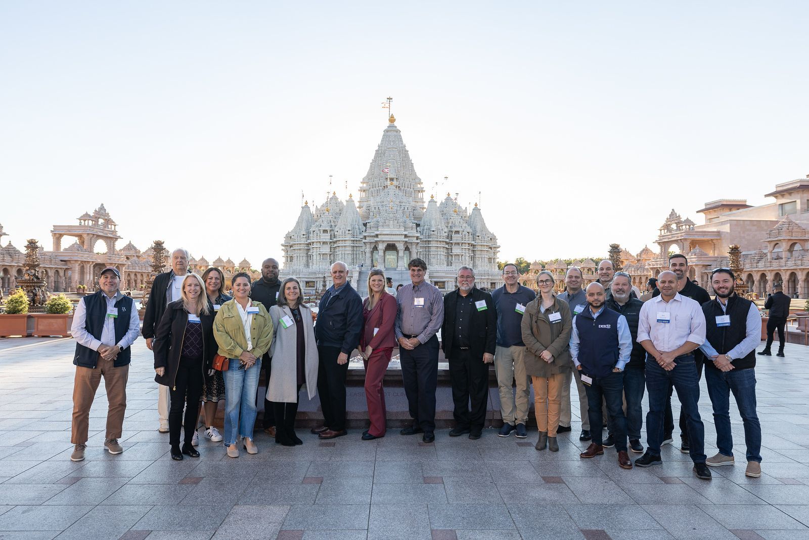 A group of people are posing for a picture in front of a temple.