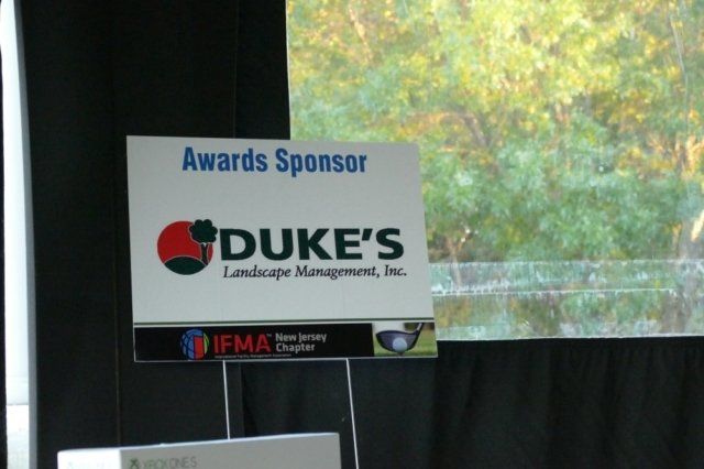 A sign that says awards sponsor duke 's landscape management inc.
