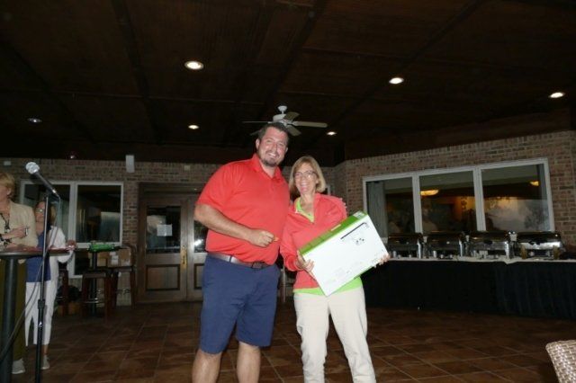 A man and a woman are standing next to each other holding a certificate.
