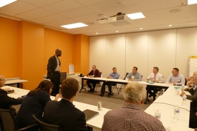 A man is giving a presentation to a group of people
