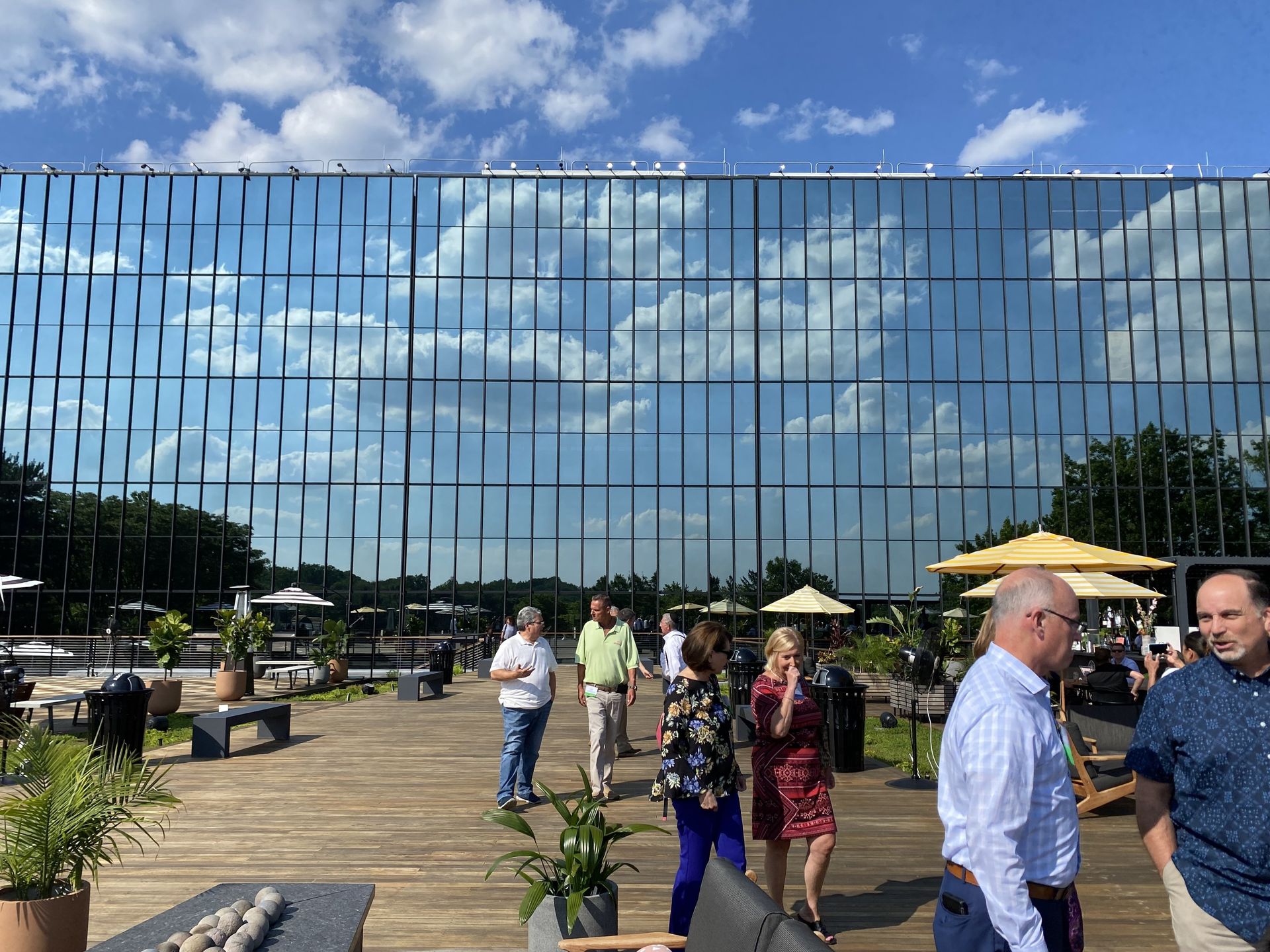 A group of people are standing in front of a large building.
