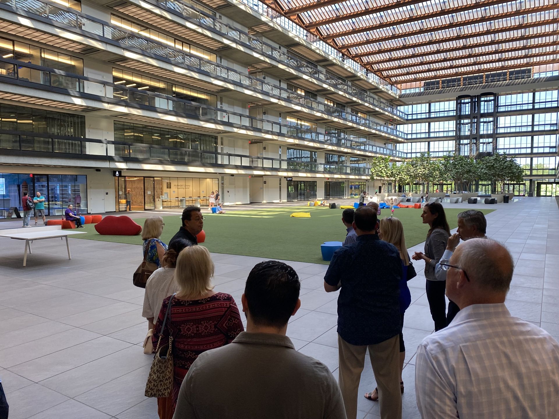 A group of people are standing in a large building.