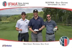 Three men are posing for a picture on a golf course