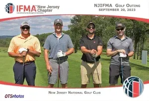 Four men are posing for a picture on a golf course