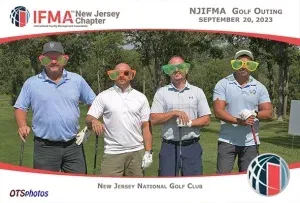 A group of men wearing sunglasses are standing on a golf course.