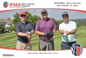 Three men are posing for a picture on a golf course