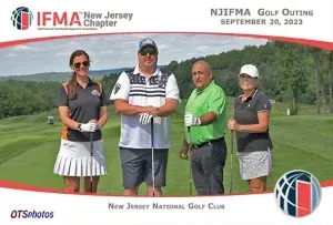 A group of people posing for a picture on a golf course