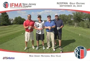 A group of men are posing for a picture on a golf course