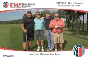 A group of men are posing for a picture on a golf course