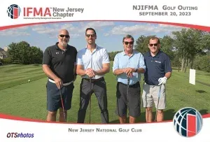 Four men are posing for a picture on a golf course