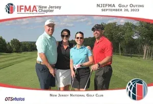 A group of people posing for a picture on a golf course