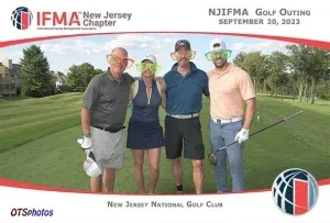 A group of people posing for a picture on a golf course