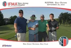 A group of men are posing for a picture on a golf course