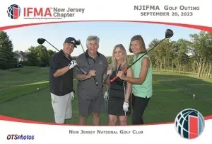 A group of people holding golf clubs on a golf course