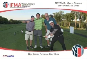 A group of men are posing for a picture on a golf course