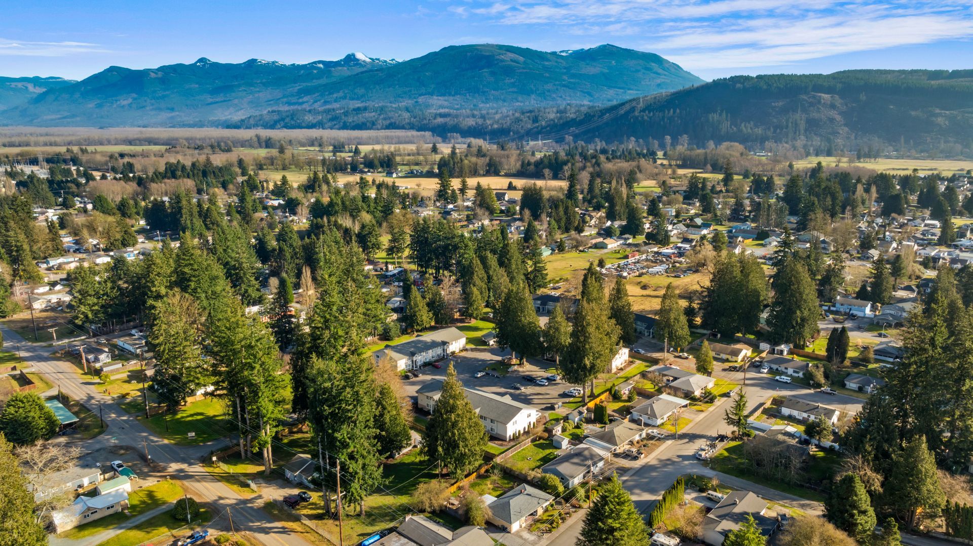 An aerial view of a residential area with mountains in the background.