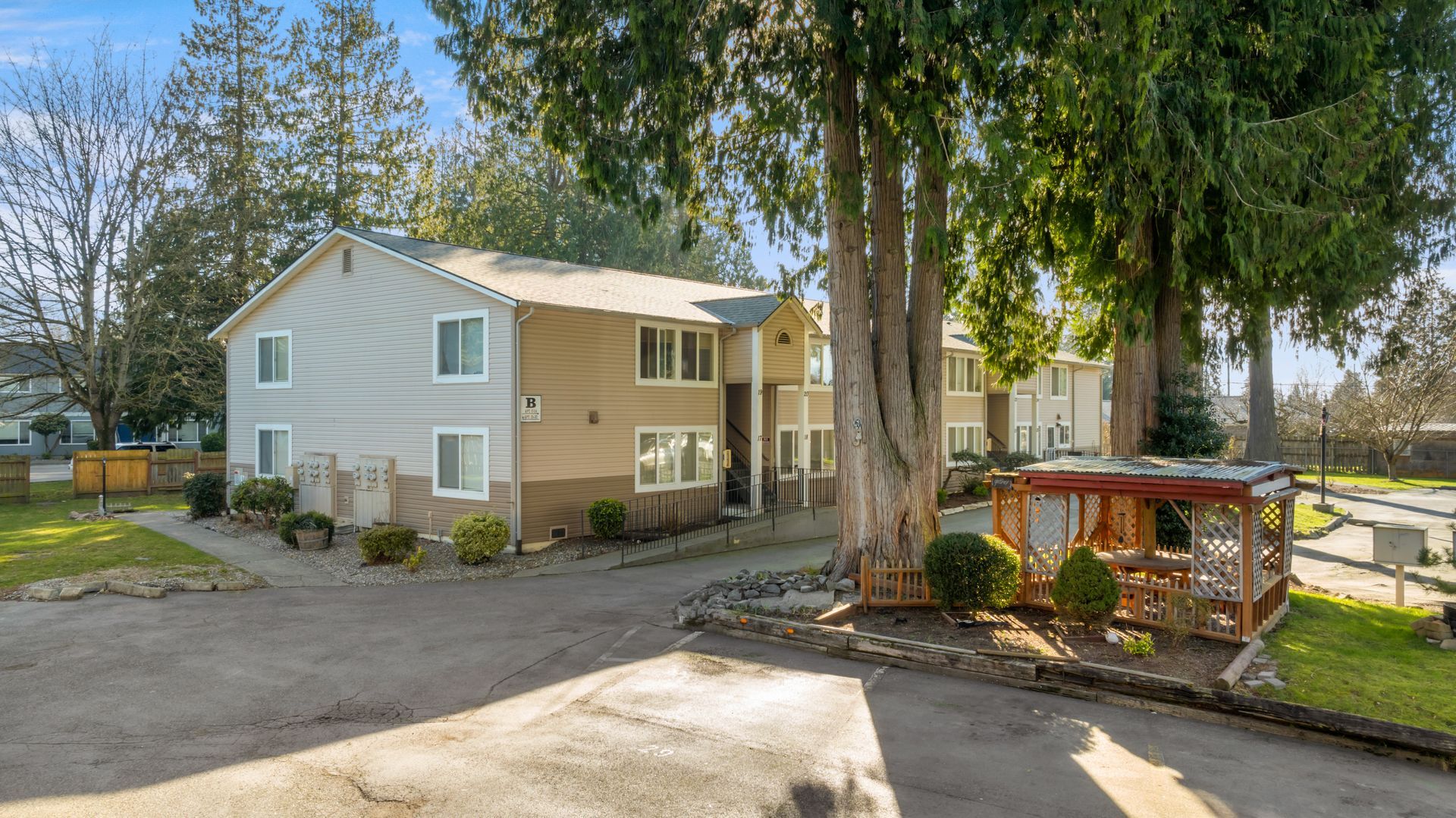 A house with a lot of windows and trees in front of it.