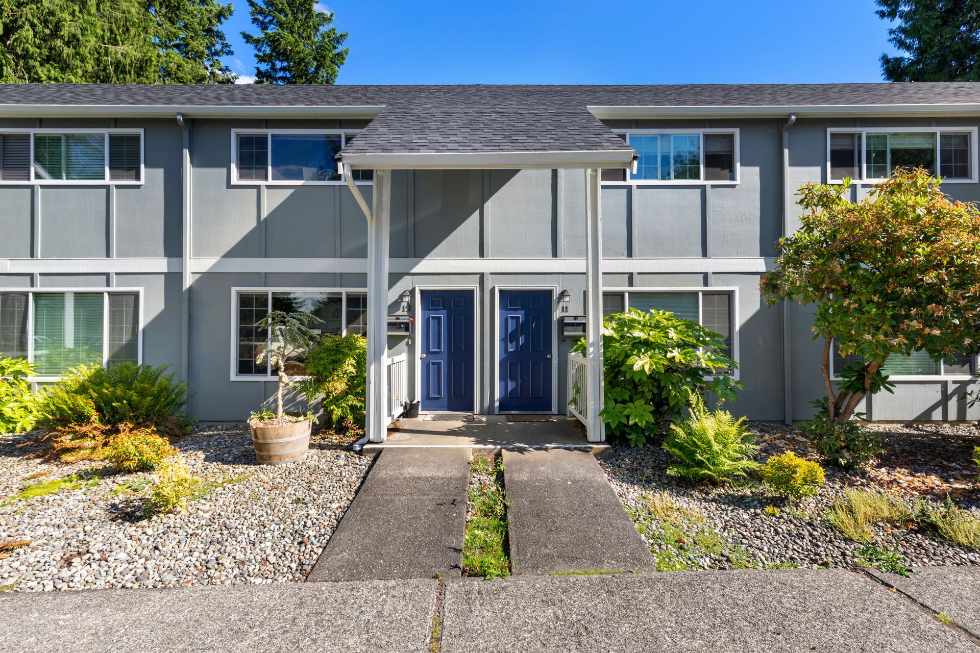 A gray apartment building with a blue door