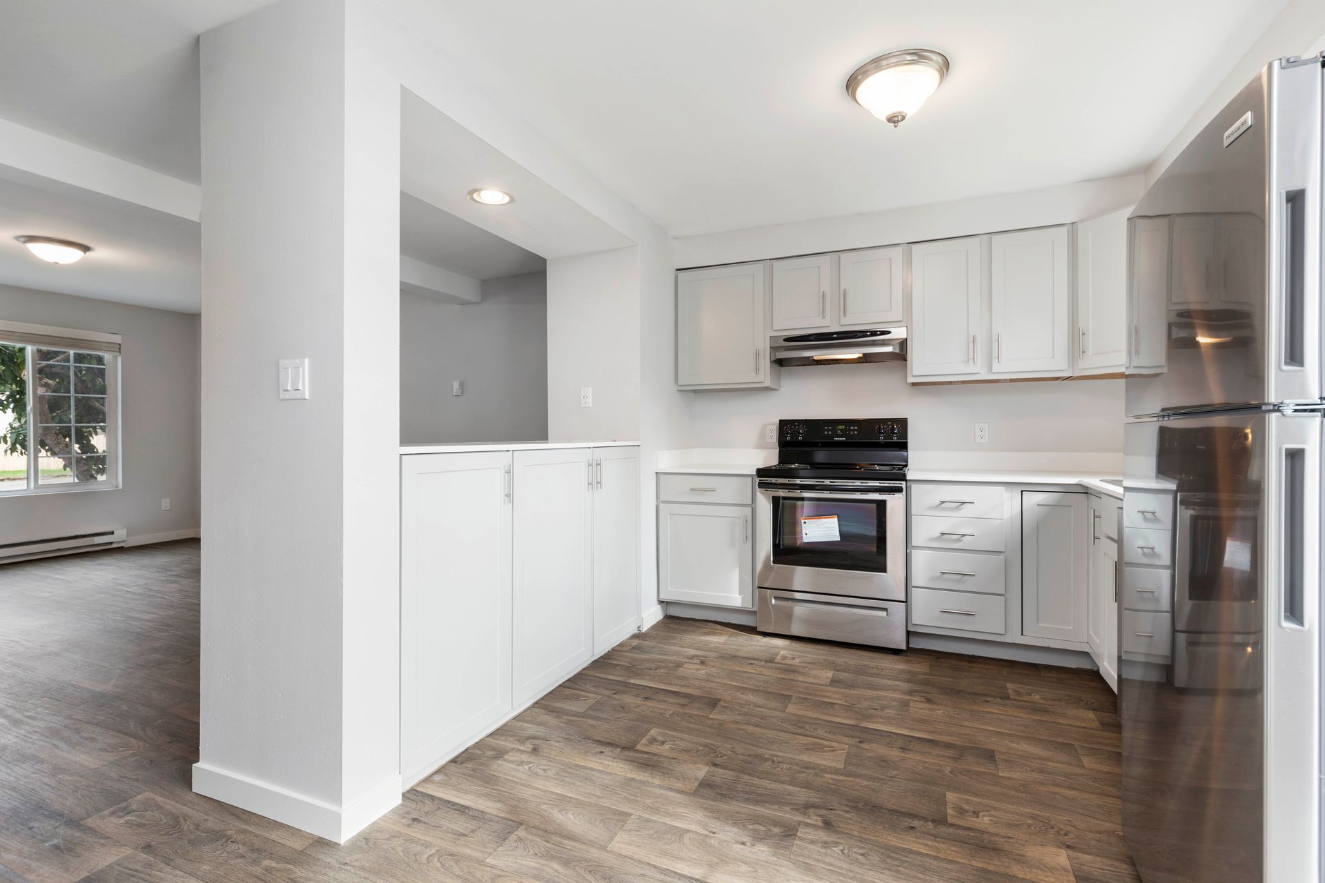 A kitchen with white cabinets and stainless steel appliances.