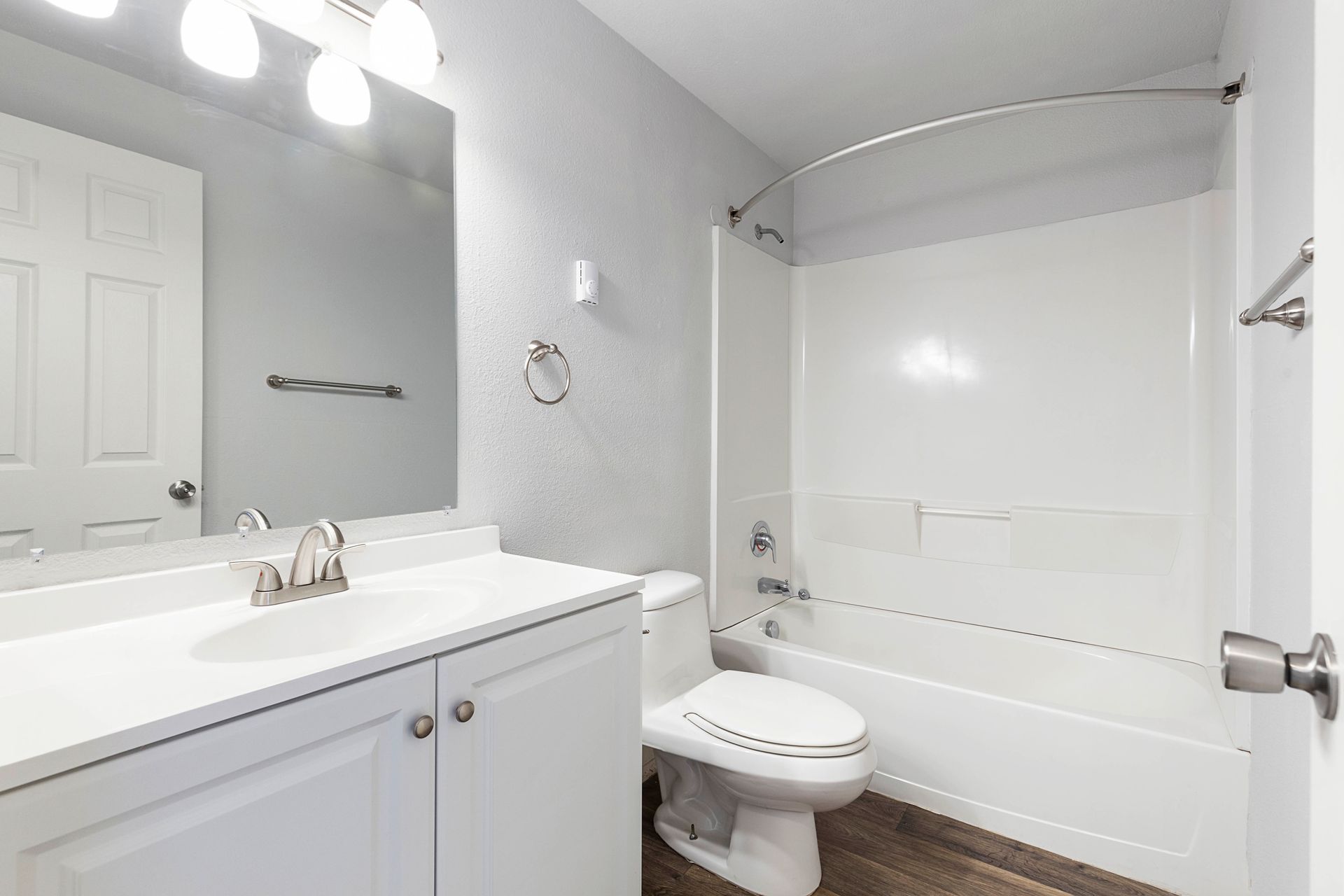 A bathroom with a toilet , sink , and bathtub.
