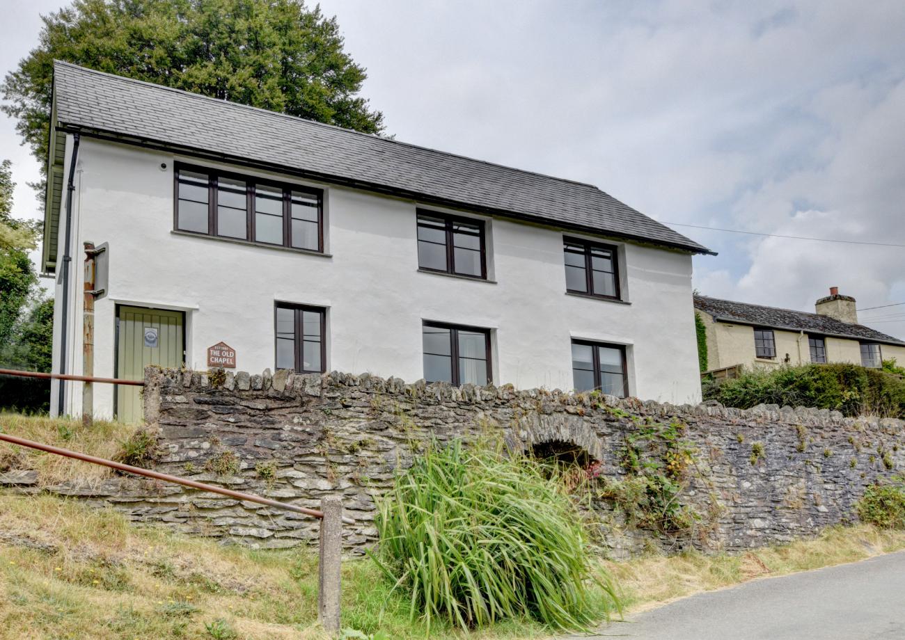 External photo of The Old Chapel showing the wall of lane