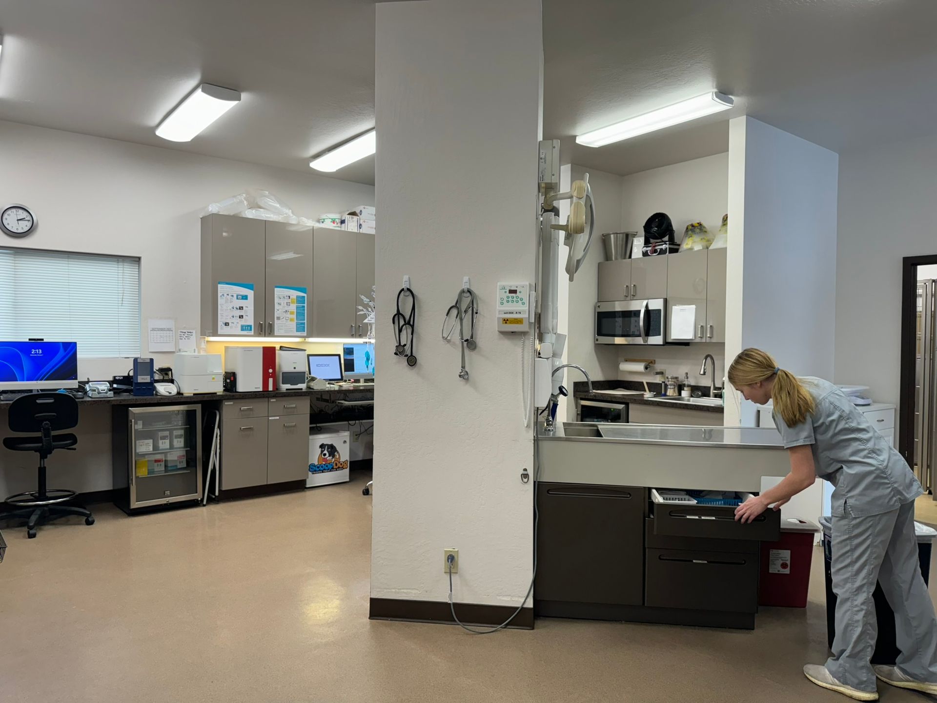 a nurse is cleaning a sink in a dental office .