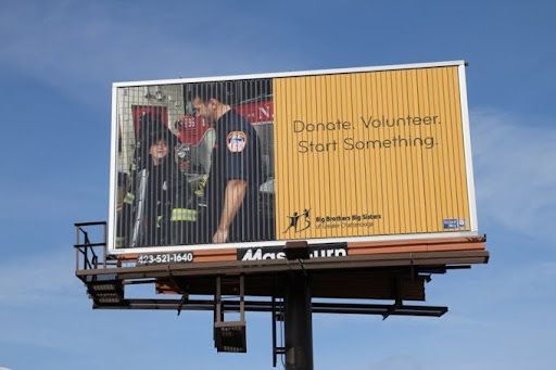 a billboard that says donate volunteer start something