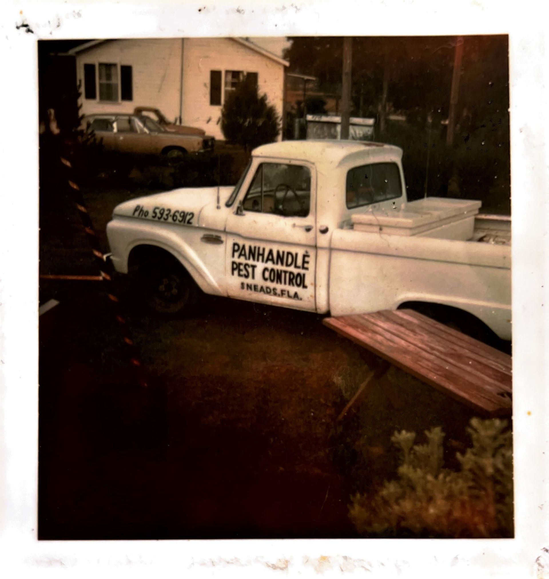 White Panhandle Pest Control truck parked in front of a house; Pensacola, FL.