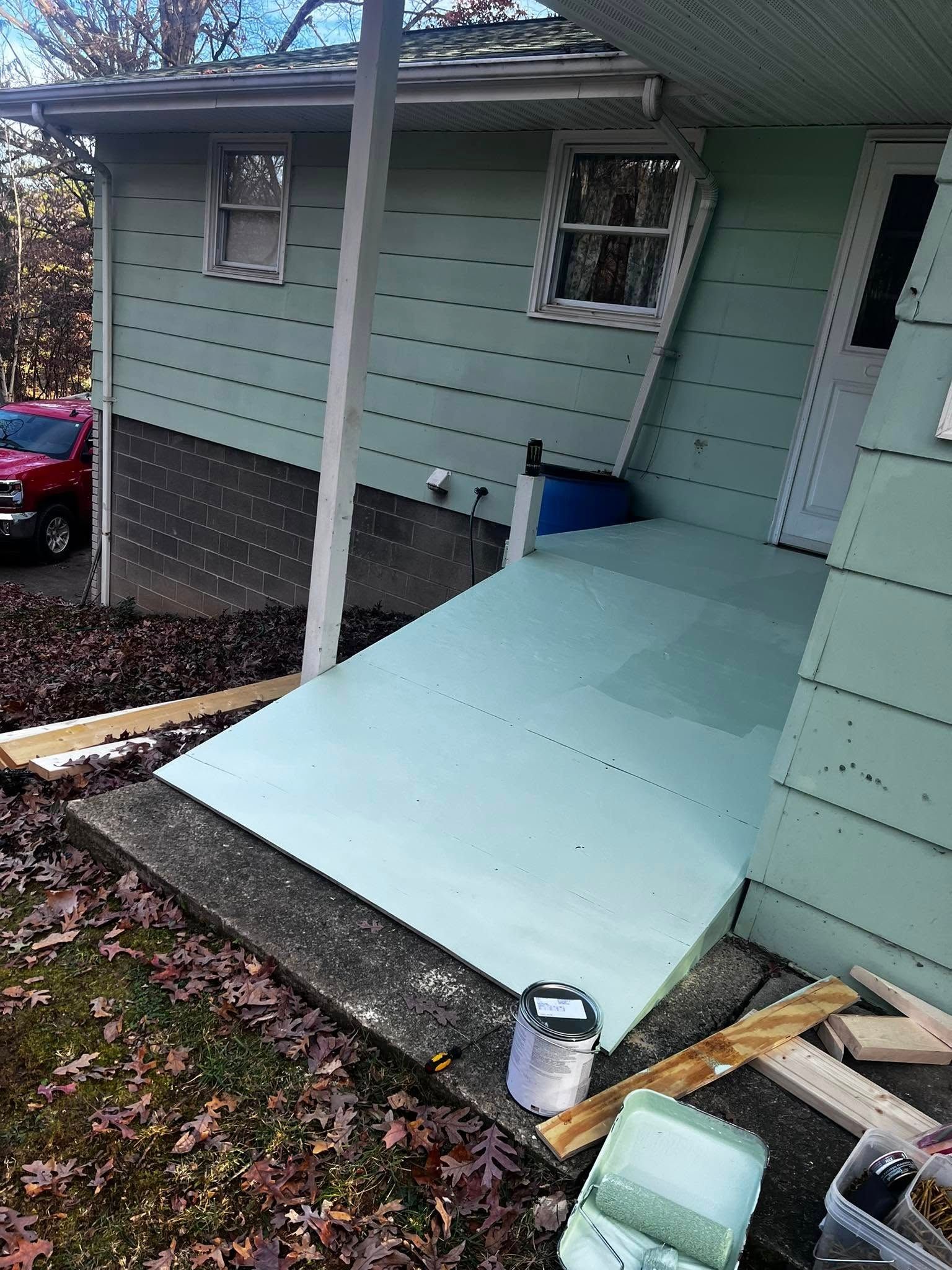 A house with a ramp being built on the side of it.