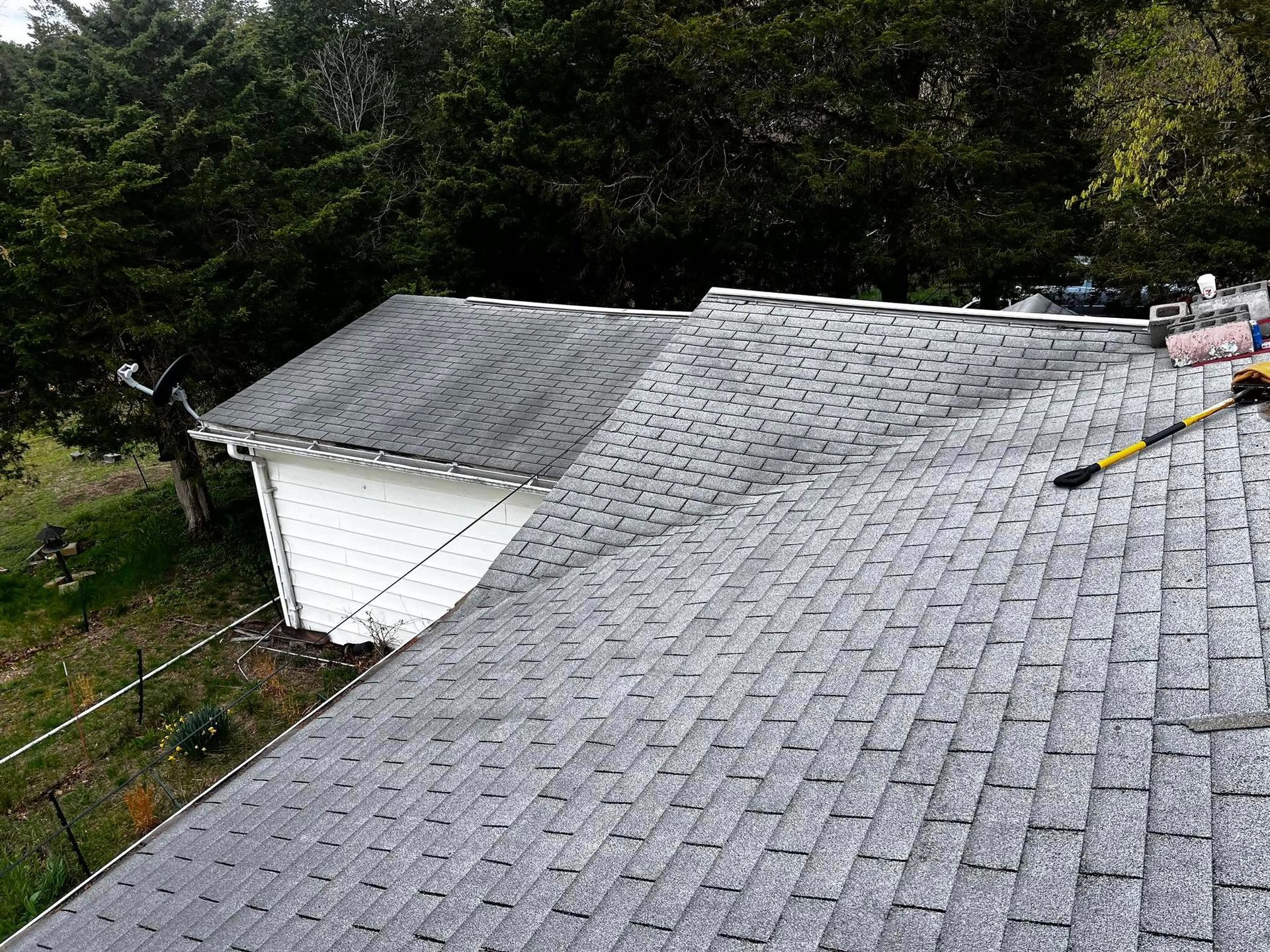 A person is working on the roof of a house.
