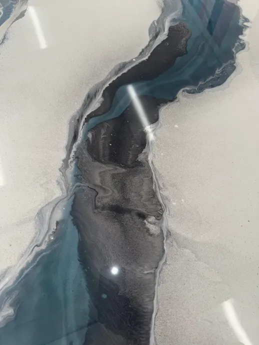 Abstract marbled surface with flowing gray, blue, and white veins