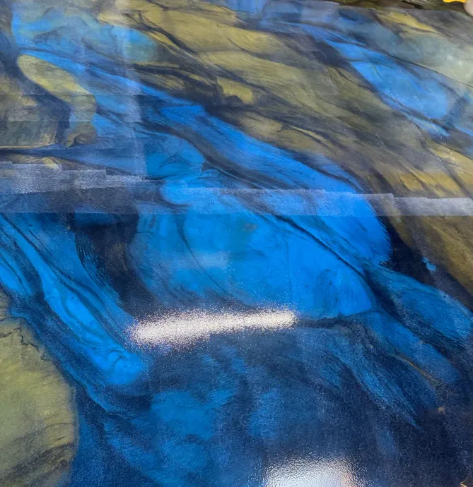 Abstract painting with sweeping blue, gray, and olive brushstrokes and a small white highlight