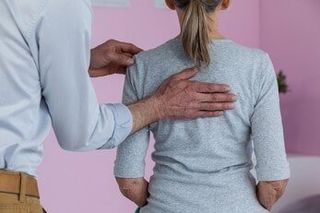 Physiotherapist giving neck massage to female patient — Chiropractic in Los Angeles, CA