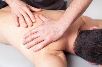 Back massage given to a young man — Chiropractic in Los Angeles, CA