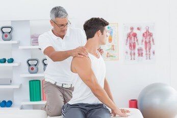 Doctor doing back adjustment — Chiropractic in Los Angeles, CA