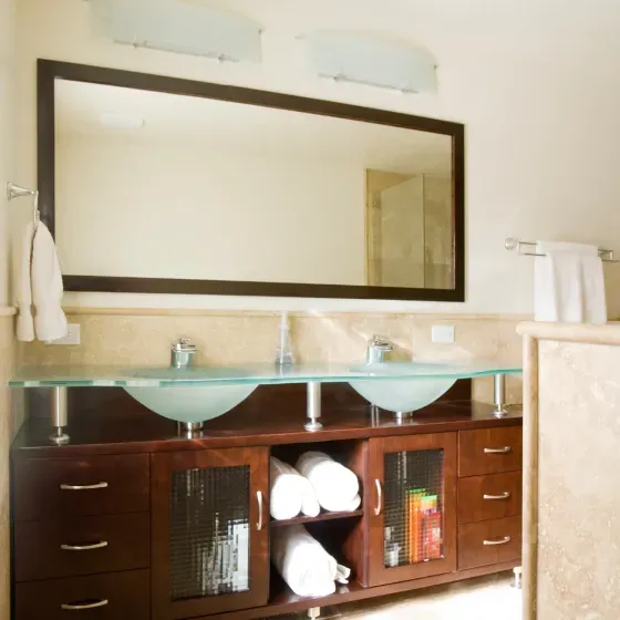 A bathroom with two sinks and a large mirror