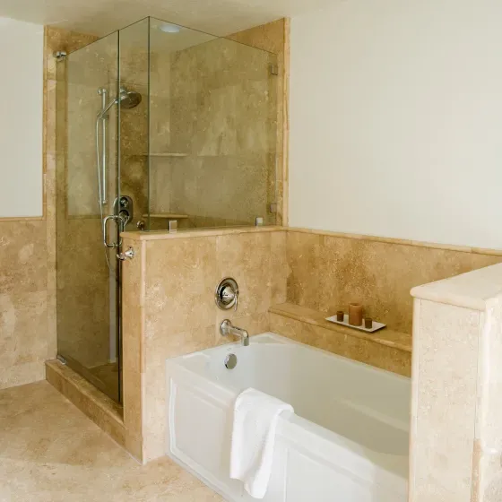A bathroom with a bathtub and a walk in shower