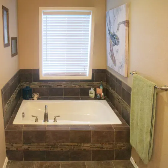 A bathroom with a large tub and a window