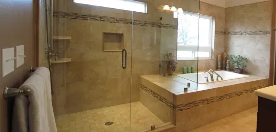 A bathroom with a walk in shower and a bathtub.